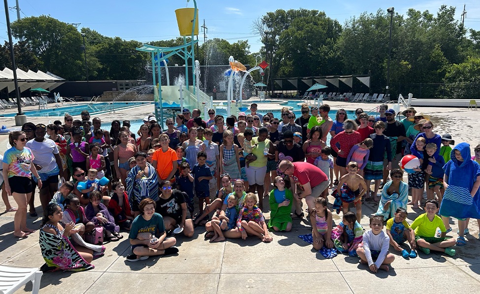 Dozens of people at a community swimming pool