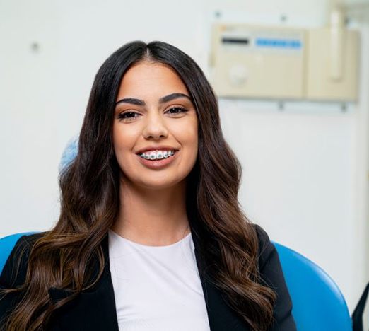 Smiling patient with traditional braces
