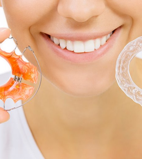 Woman holding two different types of retainers
