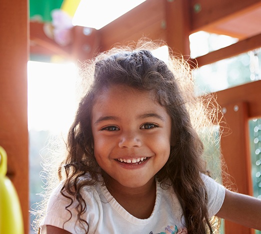 Little girl on playground smiling