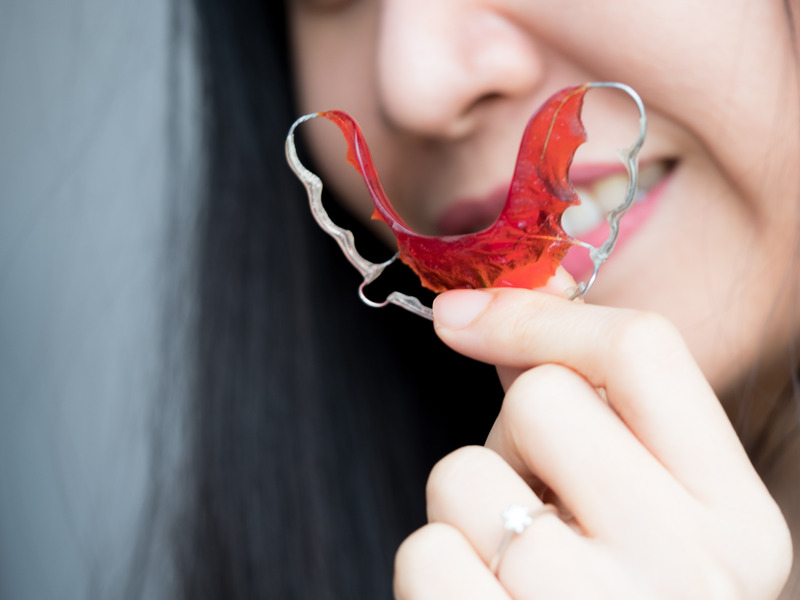 Patient holding their retainer