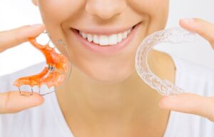 Woman holding retainers. 